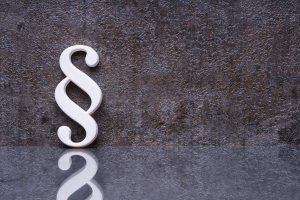 Paragraphensymbol vor grauem Hintergrund